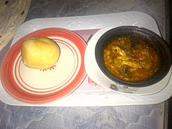 Eba served with Fresh fish banga soup in a clay pot.jpg