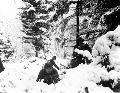 American 290th Infantry Regiment infantrymen fighting in snow during the Battle of the Bulge.jpg