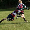 Schoolkids doing a rugby tackle