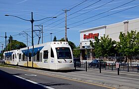 Yellow Line train passing Fred Meyer at Interstate & Lombard (2015)