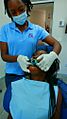 Zambian orthodontist working on a Cameroonian in Lusaka