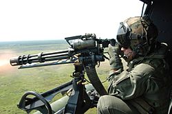 Archivo:GAU-17 machine gun fired from UH-1N Huey in 2006