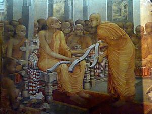 Archivo:Buddhaghosa with three copies of Visuddhimagga