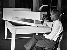 Seth B. Nicholson sits at his spectroscope.jpg