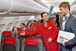 Archivo:Austrian Airlines flight attendant and passenger