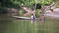 Boys in a canoe on the Gran Rio river.jpg