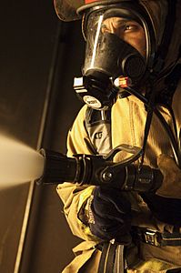 US Navy 110126-N-6903G-343 A Sailor battles a main space fire during shipboard integrated team training at the Center for Naval Engineering Learnin