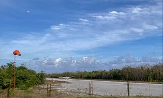 The moon, a windsock and a Cessna on the small runway. Aeropuerto Nacional de Playa del Carmen, Quintana Roo, Mexico.jpg