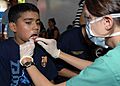 US Navy 090628-N-6259S-001 Capt. Amber Heller examines a Salvadoran child's teeth during a Continuing Promise 2009 medical community service project in Loma Larga, El Salvador