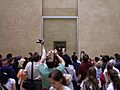Visitors of Louvre in front of Mona Lisa