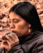 Amerindian woman playing an inca ocarina