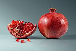 Pomegranate fruit - whole and piece with arils.jpg