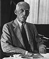 Secretary of the Treasury Mellon, seated at his desk, June 14, 1929